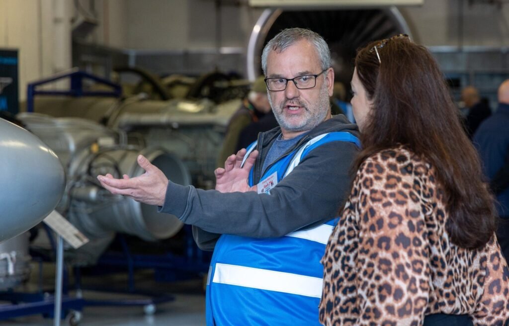A volunteer guide showing visitors around
